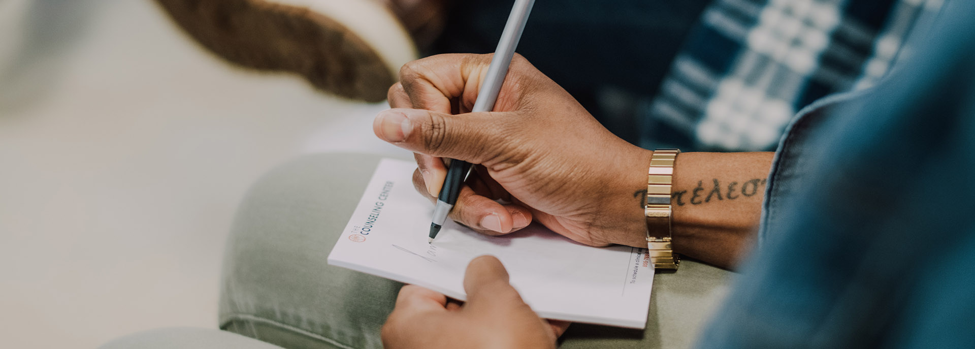 a man writing notes in a group session at Philadelphia