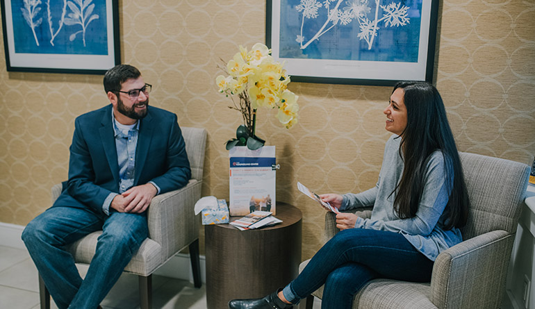 man and woman chatting at the counseling center lobby area