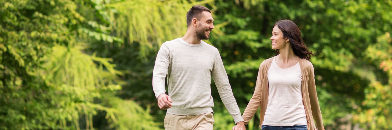 A couple walking hand in hand at a park during summer season enjoying life after rehab in Philadelphia